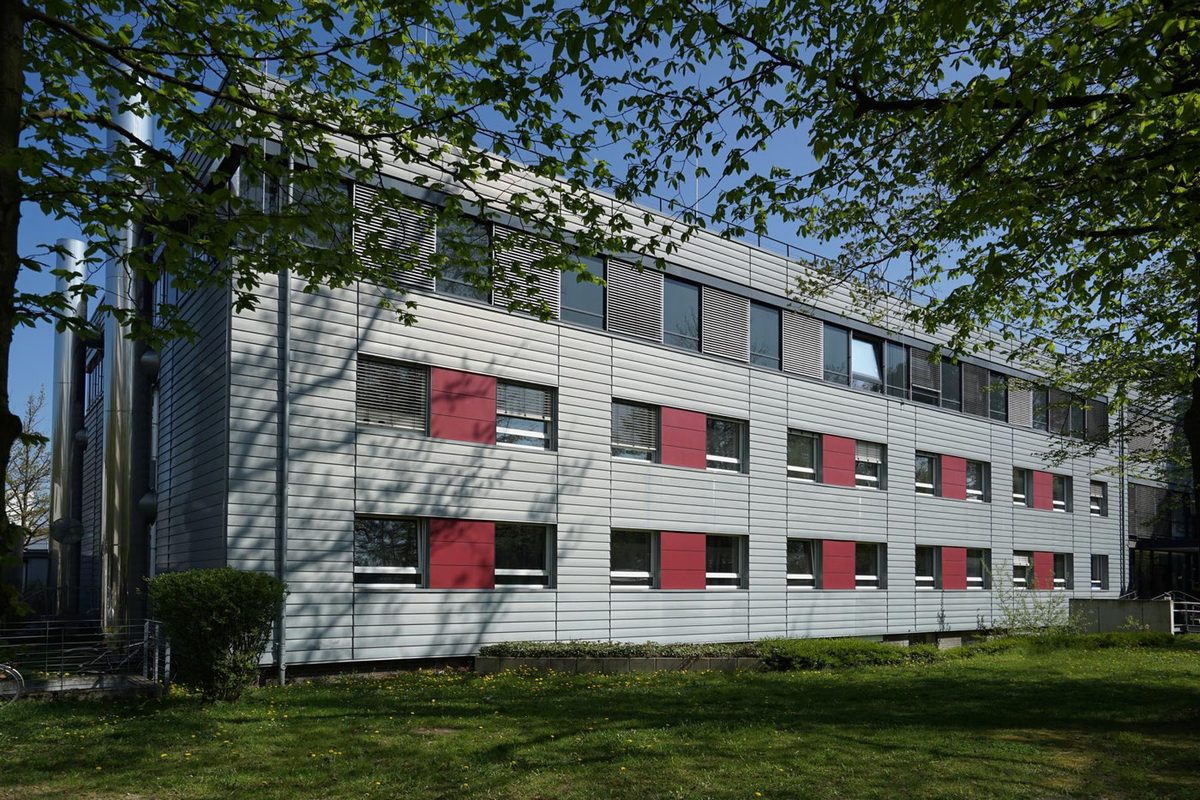 Laborgebäude mit grauer Fassade und roten Akzenten